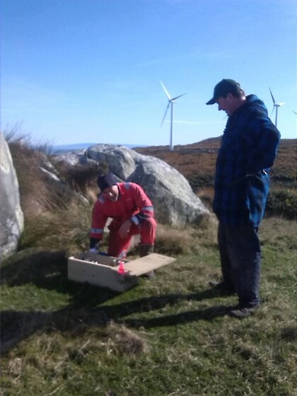 Peter Leask,and Rex Ryan with one of our mustelid traps at Flat Hill Wind Farm.